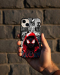 Phone case with Spider-Man design held against a brick wall