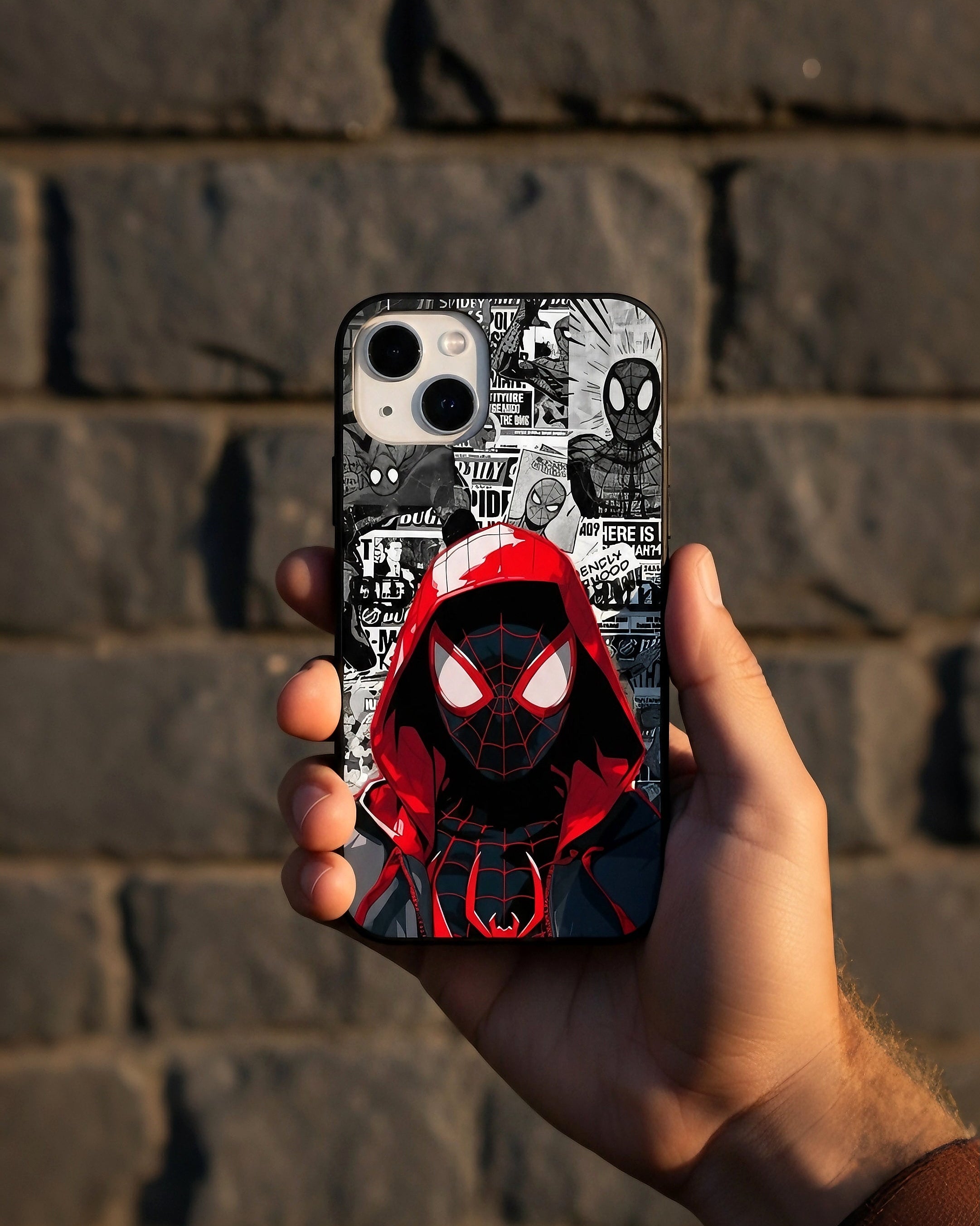 Phone case with Spider-Man design held against a brick wall